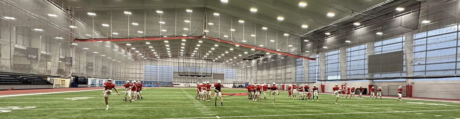 High School Football Practicing in Field House